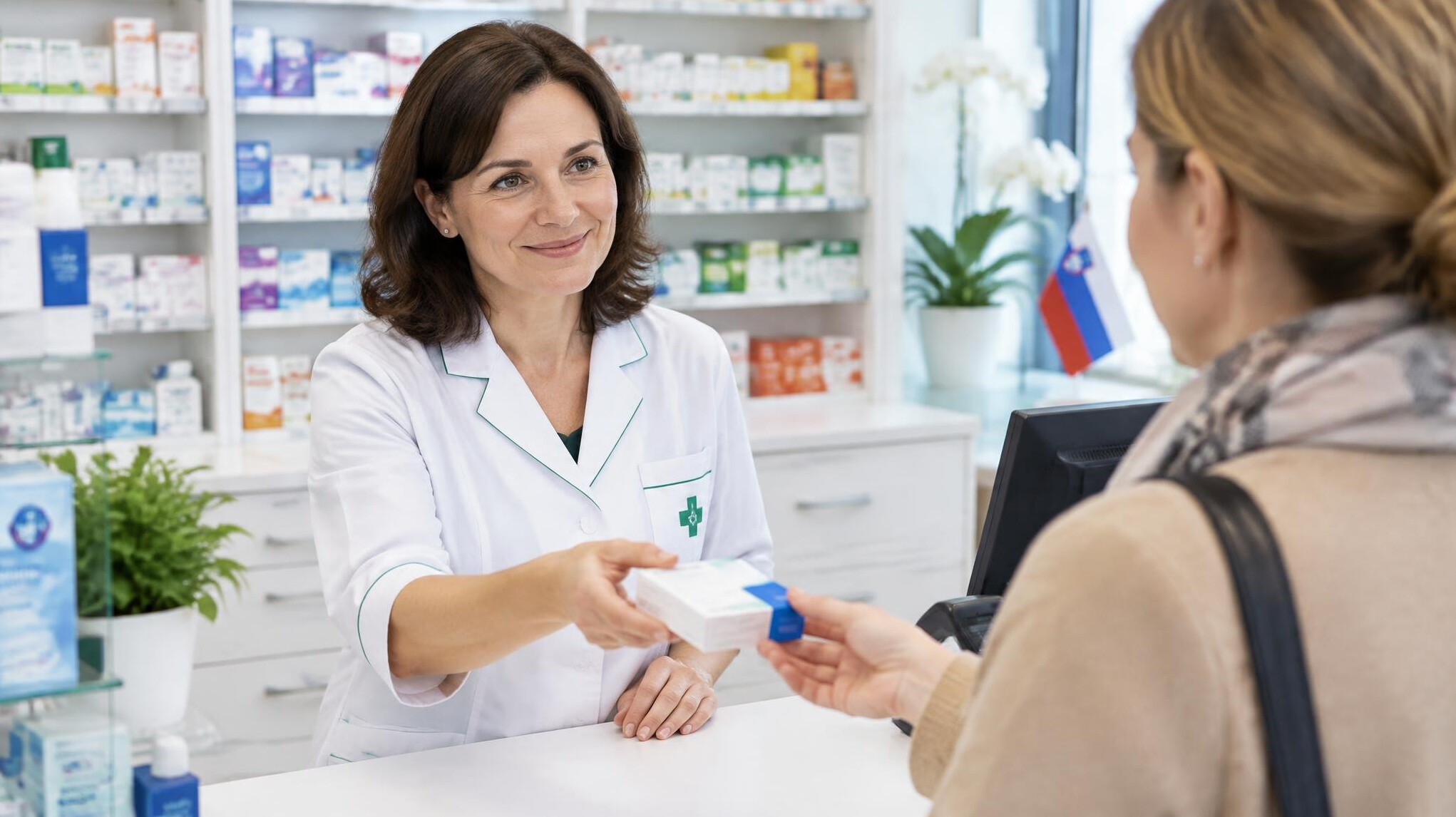 Pharmacist handing medication package to customer